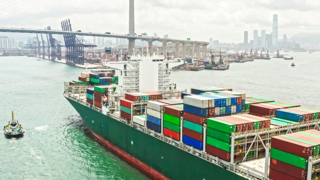 Large cargo ship transporting shipment container arriving Hong Kong port